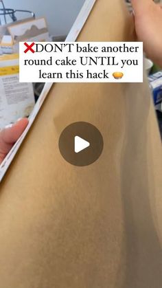 someone is holding up a piece of cardboard with the words don't bake another round cake until you learn this hack