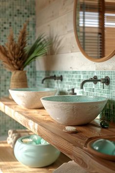 two bowls are sitting on a wooden shelf in the bathroom, one is green and the other is white