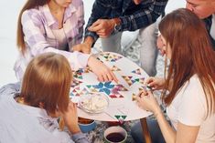 a group of people sitting around a table together