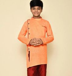 This exquisite Kids Kurta Set is specially crafted for Birthdays , Indian weddings and festivals. The set includes a beautifully self-embroidered Dopion art silk top, paired with your choice of a ready-made Dhoti, Chudidar or Patiyala bottom. Kids Indo-Western Sherwani in side open style * Style - Kids Indo-western Sherwani * Fabric - Premium Cotton  * Color - Red/Green/Blue/Orange/Peach * Work Type - Side open + Pattern work on Cotton  * Bottom - Paired with Matching Silk Pant Kids Sherwani Boys, Boys Sherwani, Kids Sherwani, Boys Party Wear, Kids Dress Boys, Kids Kurta, Baby Boy Clothing Sets, Red Suit, Indo Western