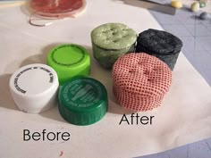 four different colored containers sitting on top of a white tablecloth next to each other