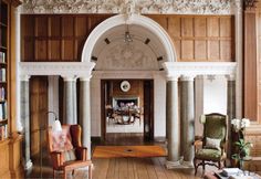 an ornately decorated room with columns and chairs