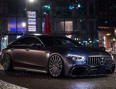 a car parked in front of a building at night