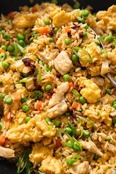 a bowl filled with rice, peas and chicken