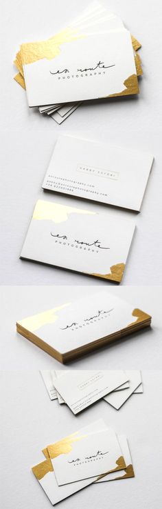 some white and gold business cards on top of each other