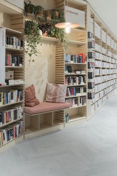 a room filled with lots of books on shelves next to a wall full of books