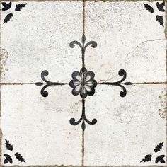 a white and black tile with an ornate design