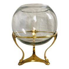 a clear glass bowl on a gold stand