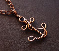 a close up of a metal object on a leather surface with a chain attached to it