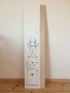 a wooden block with a drawing of two deer hugging each other on it's side