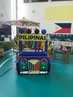 a car made out of cardboard sitting on top of a blue floor