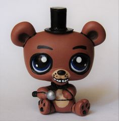 a little brown bear with big eyes and a top hat