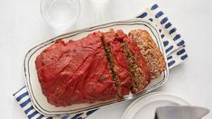 meatloaf on a platter with two slices cut out and ready to eat