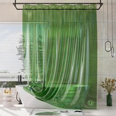 a green shower curtain in a bathroom next to a bathtub