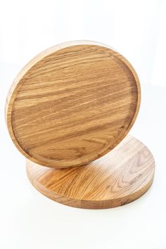 two wooden coasters sitting on top of each other in front of a white background