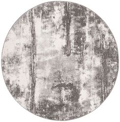 a round rug with grey and white paint on it