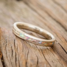 a close up of a wedding ring on a wooden surface