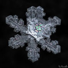 a snowflake is shown in the dark with an image of a clock on it