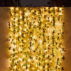 a wall covered in vines and lights