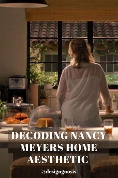 a woman standing in front of a kitchen counter with food on it and the words decoding nancy meyers home aesthetic