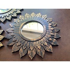 three sunflower shaped mirrors are hanging on the wall