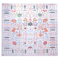 a white rug with colorful designs on it