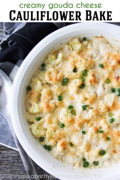 a white bowl filled with macaroni and cheese on top of a wooden table