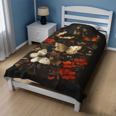 a bed in a bedroom with blue walls and wooden flooring is decorated with butterflies and flowers