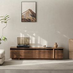 a living room scene with focus on the coffee table and chair, as well as an art piece