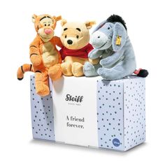 three stuffed animals sitting on top of a white box with the words seifff