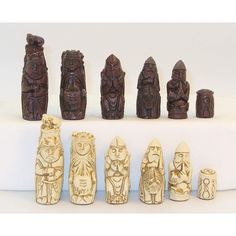 an assortment of carved wooden figurines sitting on top of a white countertop