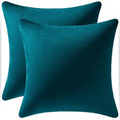 two teal velvet pillows on a white background