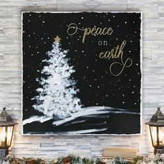 a white christmas tree painted on a black background with the words peace on earth in gold lettering