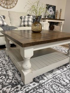 a white coffee table sitting on top of a rug