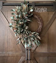 a wreath hanging on the side of a barn door