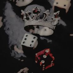 a black and white photo with dices and a crown