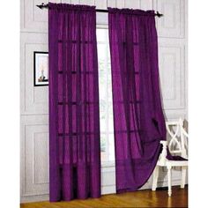 purple curtains hanging in front of a window