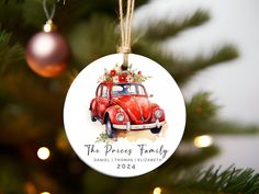 a red car ornament hanging from a christmas tree