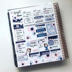 a spiral notebook covered in stickers and paper