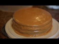 a close up of a cake on a plate with peanut butter frosting in the middle