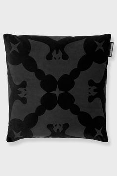 a black and white pillow with skulls on it