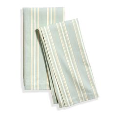 two green and white striped napkins sitting on top of each other