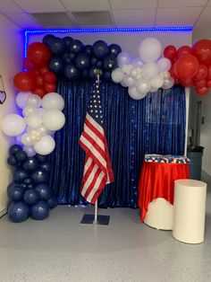 an american flag is displayed in front of balloons