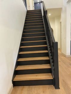 the stairs are black and have wooden treads