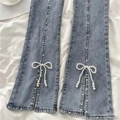 You'll look as precious as pearls in these Beaded Split Bow Jeans! These jeans offer an exciting twist on a timeless classic, with intricate beaded detailing along with a split seam to give your outfit a unique, eye-catching look. Size Chart: Size Waist (cm) Hip (cm) Length (cm) Waist (in) Hip (in) Length (in) S 63 72 94 24.80 28.35 37.01 M 67 76 94 26.38 29.92 37.01 L 71 80 95 27.95 31.50 37.40 XL 75 84 95 29.53 33.07 37.40 XXL 78 85 96 30.71 33.46 37.80 Description: Item Type: JeansJeans Style Customize Jeans Diy, Jeans With Beads, Bow Clothes Aesthetic, Beaded Jeans Diy, Jeans Pockets Ideas, Pearls On Jeans, Beads On Jeans, Elegant Denim Blue Jeans, Elegant Stretch Denim Bottoms