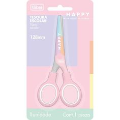 a pair of pink scissors sitting on top of a package with the words happy in it