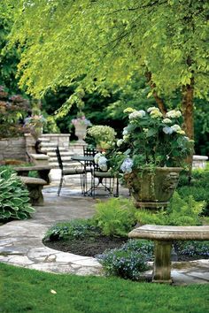 an outdoor garden with tables and chairs