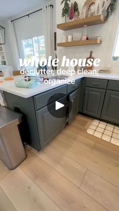 a kitchen with grey cabinets and white counter tops is featured in the video titled remote house deplaning deep clean