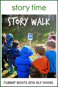 a group of children standing in front of a sign that reads story walk rubber boots and elf shoes