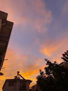 the sun is setting over an apartment building